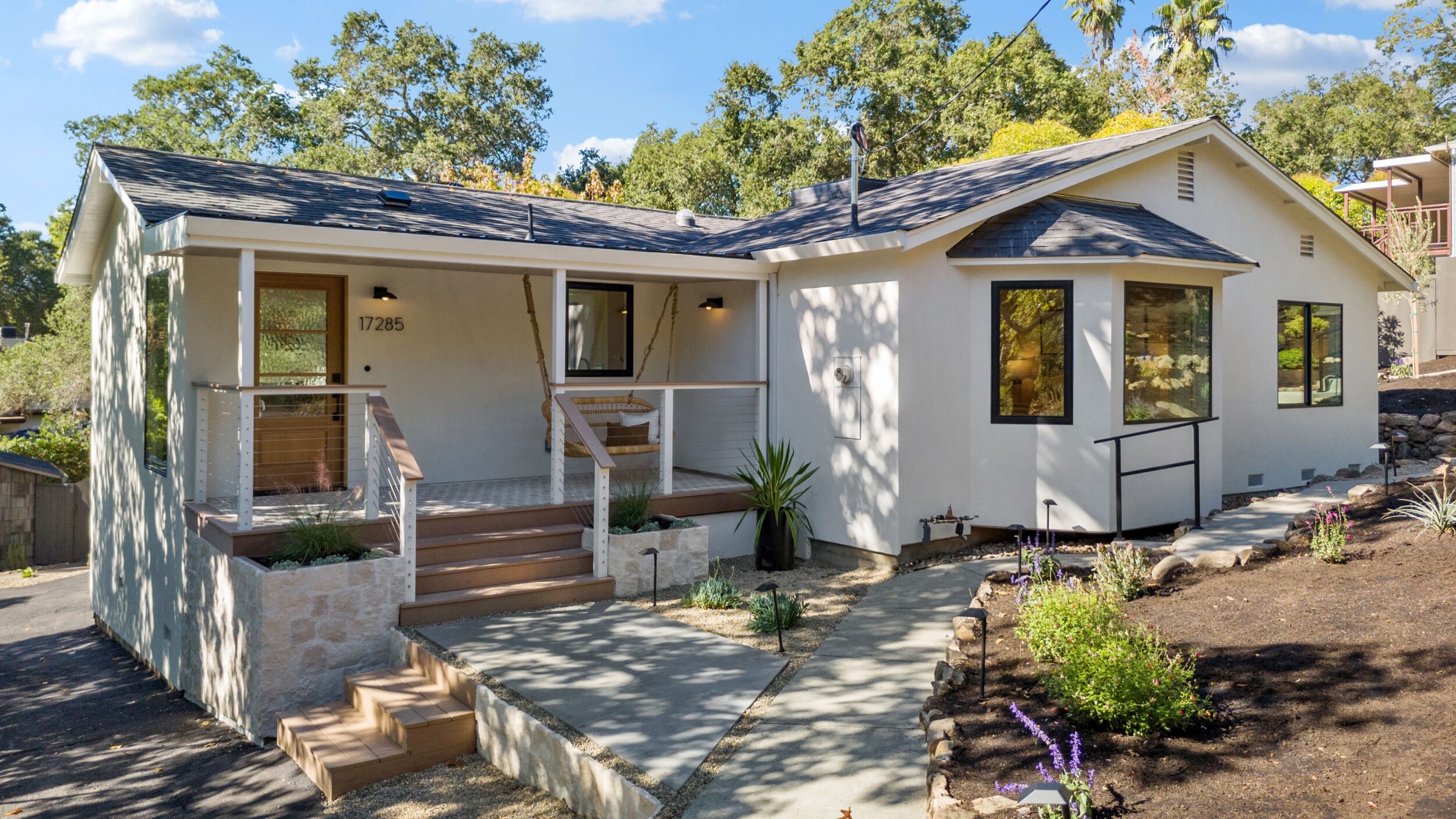 Modern single-story house with front porch.