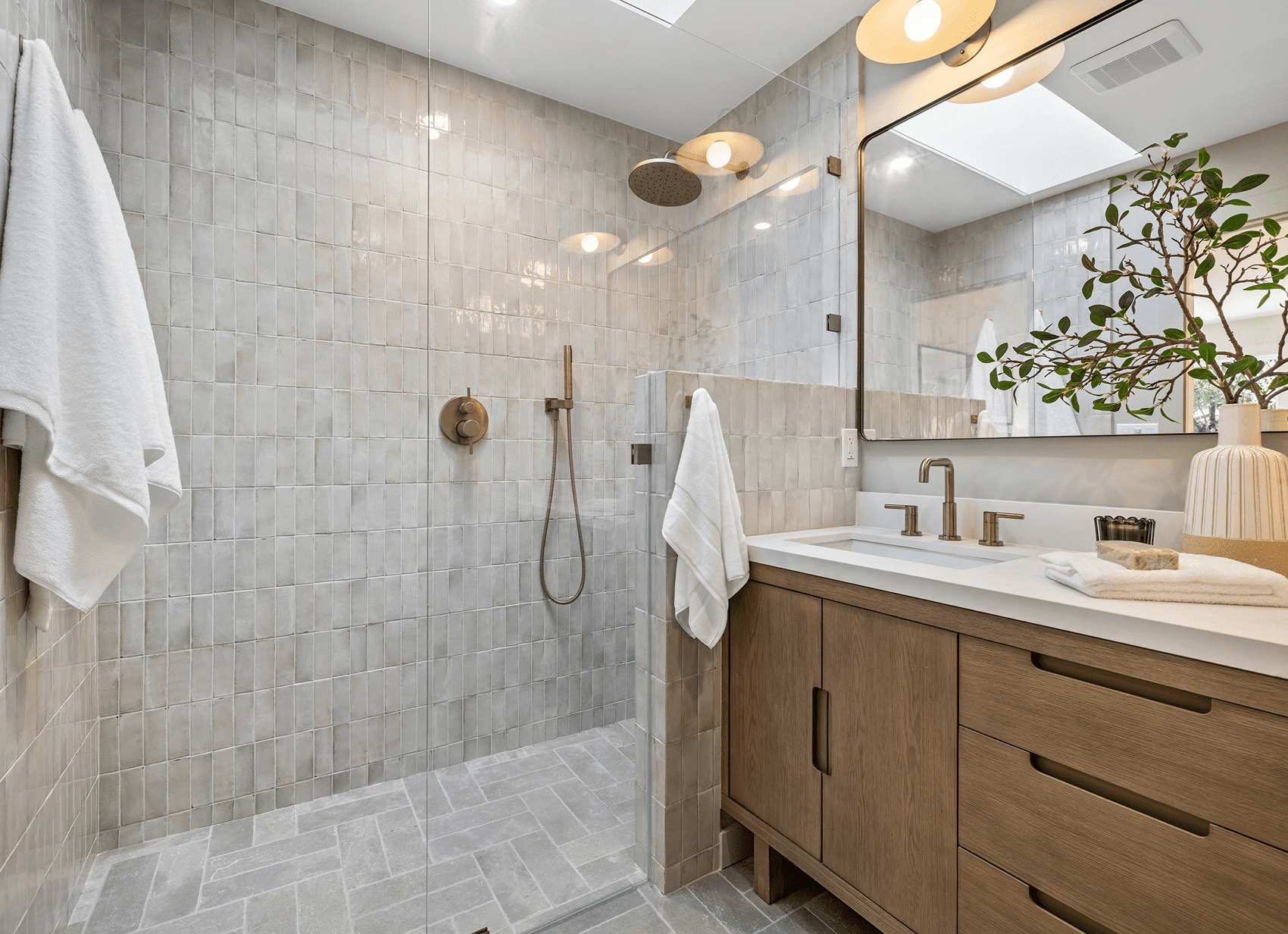 Modern bathroom with shower and wooden vanity.